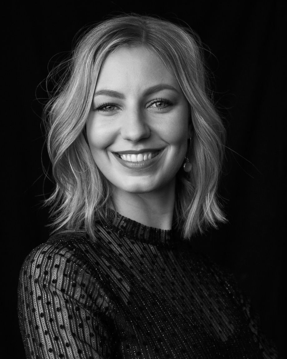 Black-and-white portrait of Michèle Clausen against a dark background